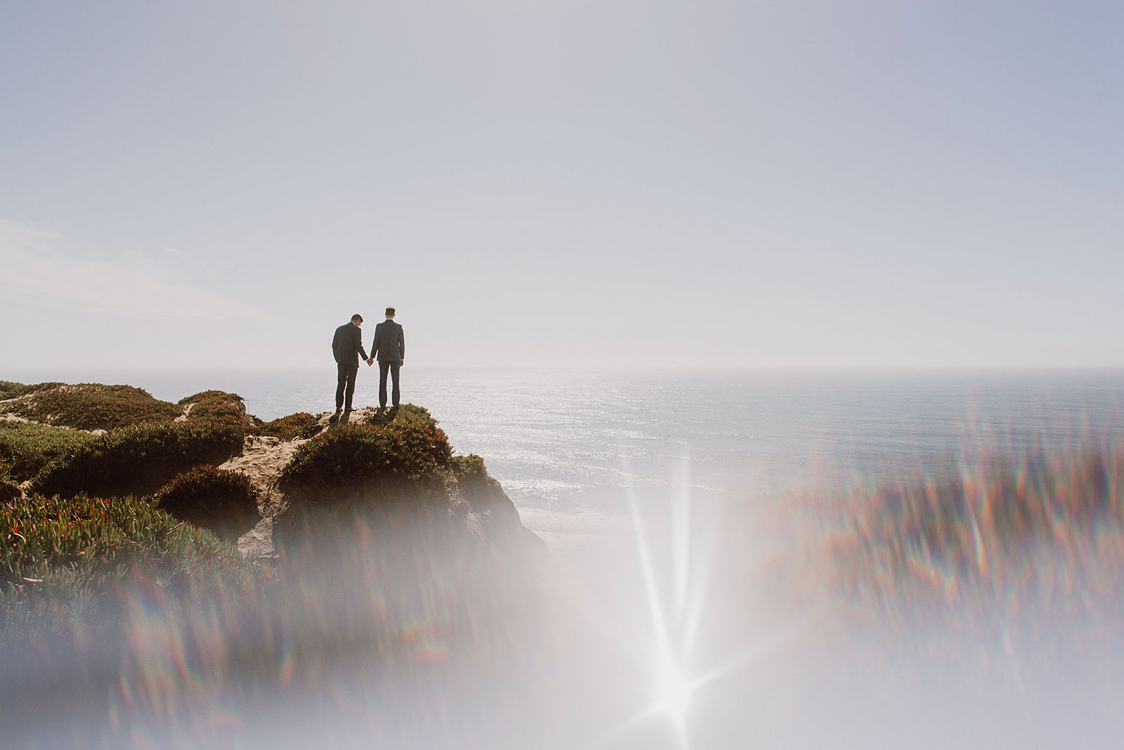 Grooms standing on a rock at Fort Funston - Foreign Cinema Wedding