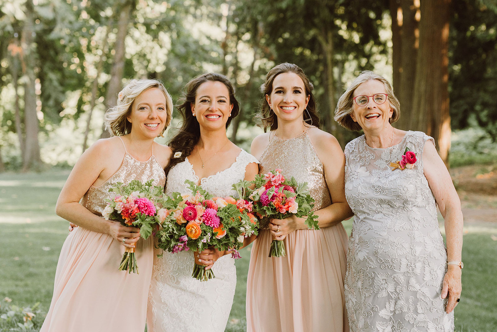 Bride posing with her family in the forest grove at a Cedarville Lodge Wedding