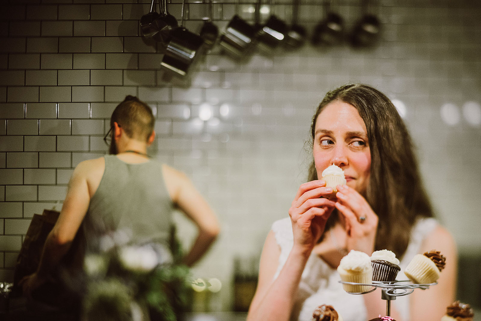 Bride sniffing a cupcake at her Intimate Restaurant Wedding in Portland, OR