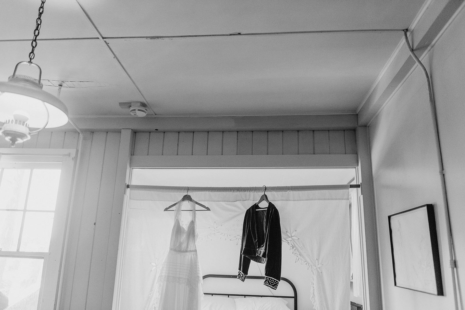 Bride's dress hanging in the suite at a SouWester Wedding in Seaview, WA