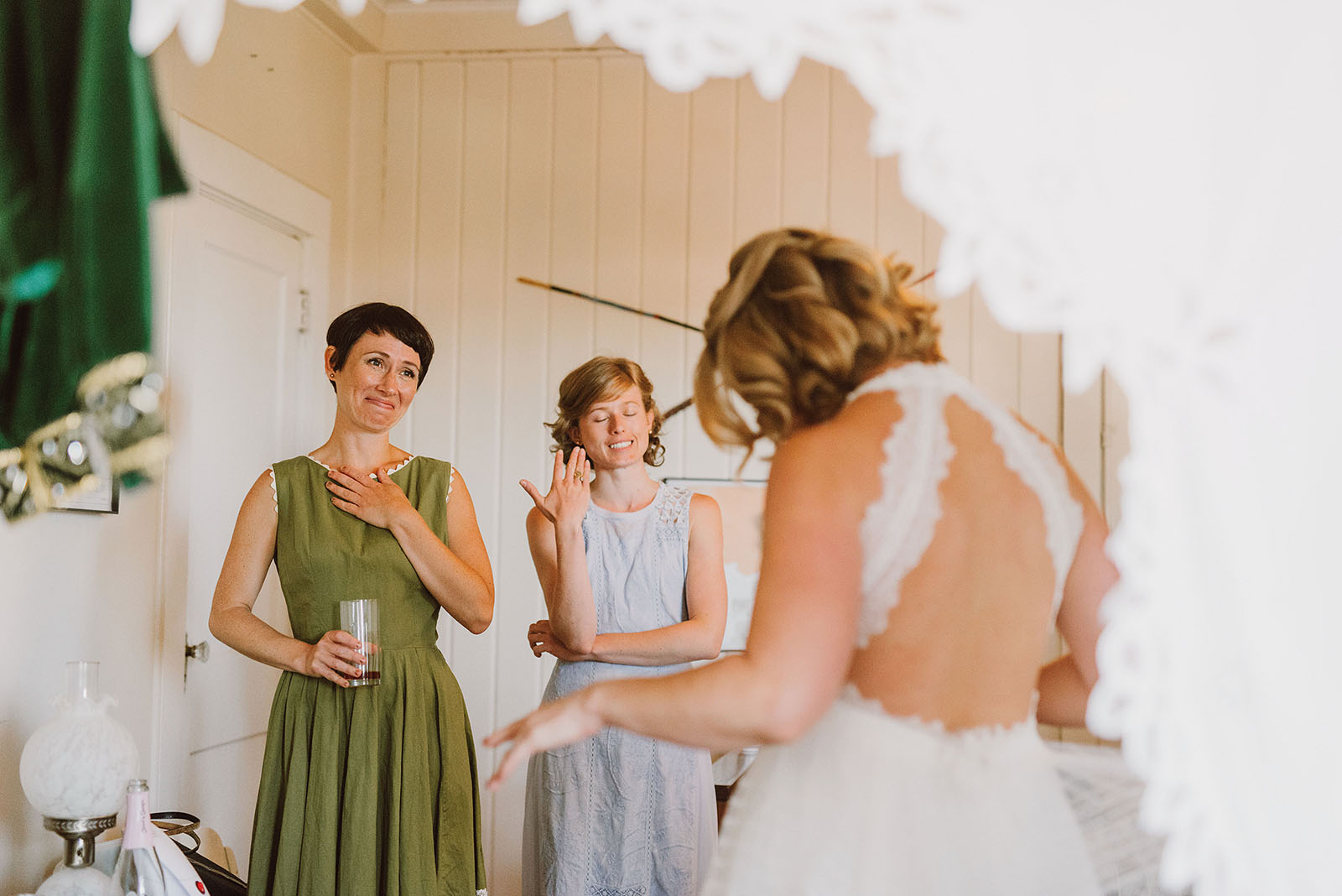 Bridesmaids watching the bride get dressed at a SouWester Wedding in Seaview, WA