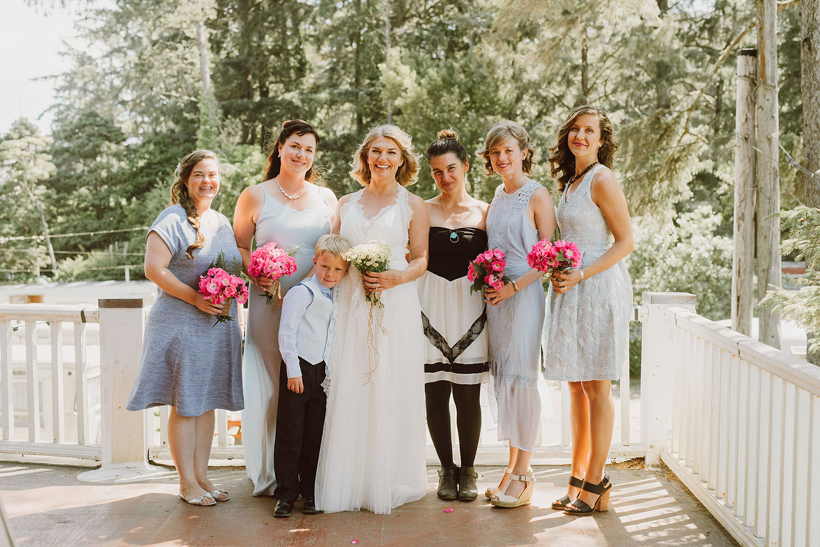 Bride with her bridesmaids on the balcony at a SouWester Wedding in Seaview, WA