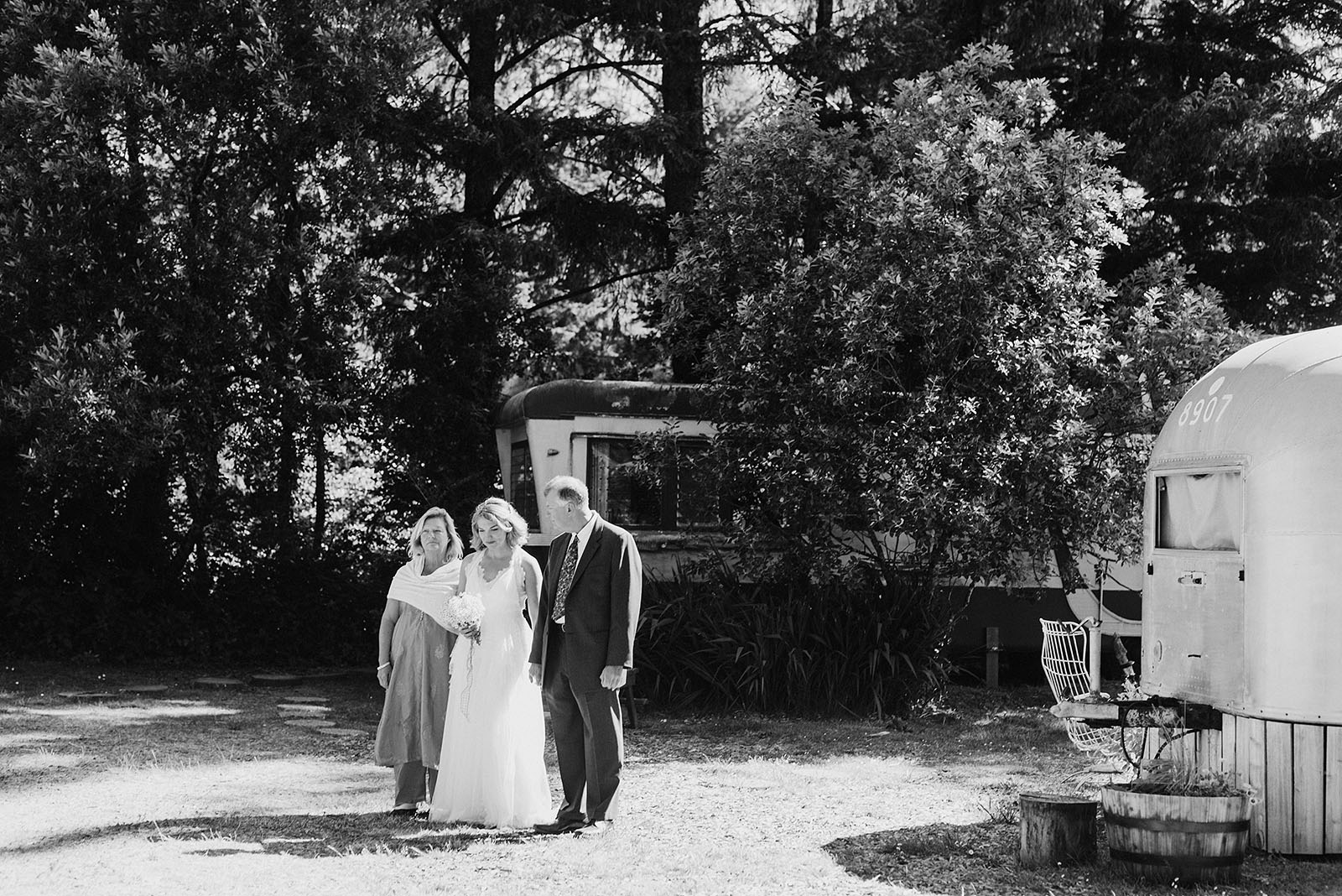 Bride walking down the aisle with her parents at a SouWester Wedding in Seaview, WA