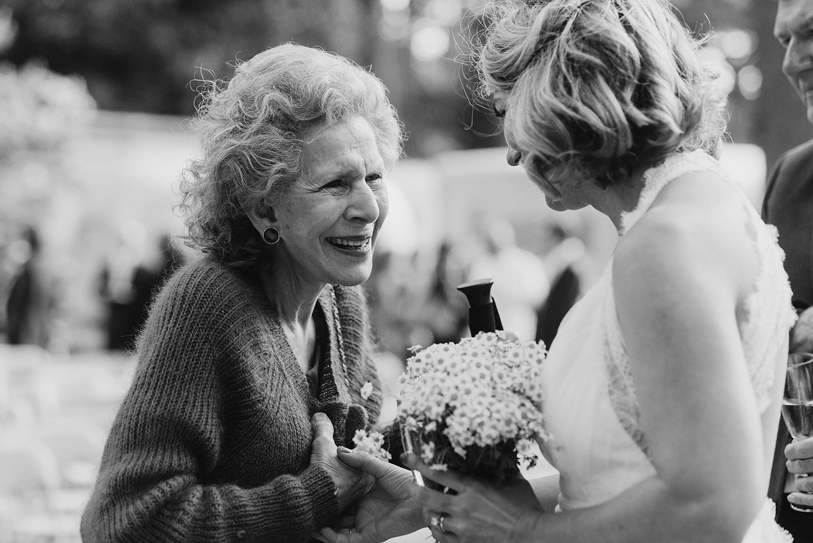 Bride talking with Groom's grandmother at a SouWester Wedding in Seaview, WA