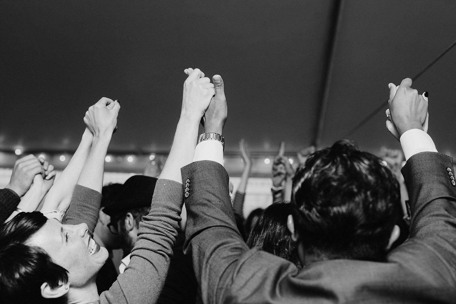 Guests holding hands during the hora at a SouWester Wedding in Seaview, WA