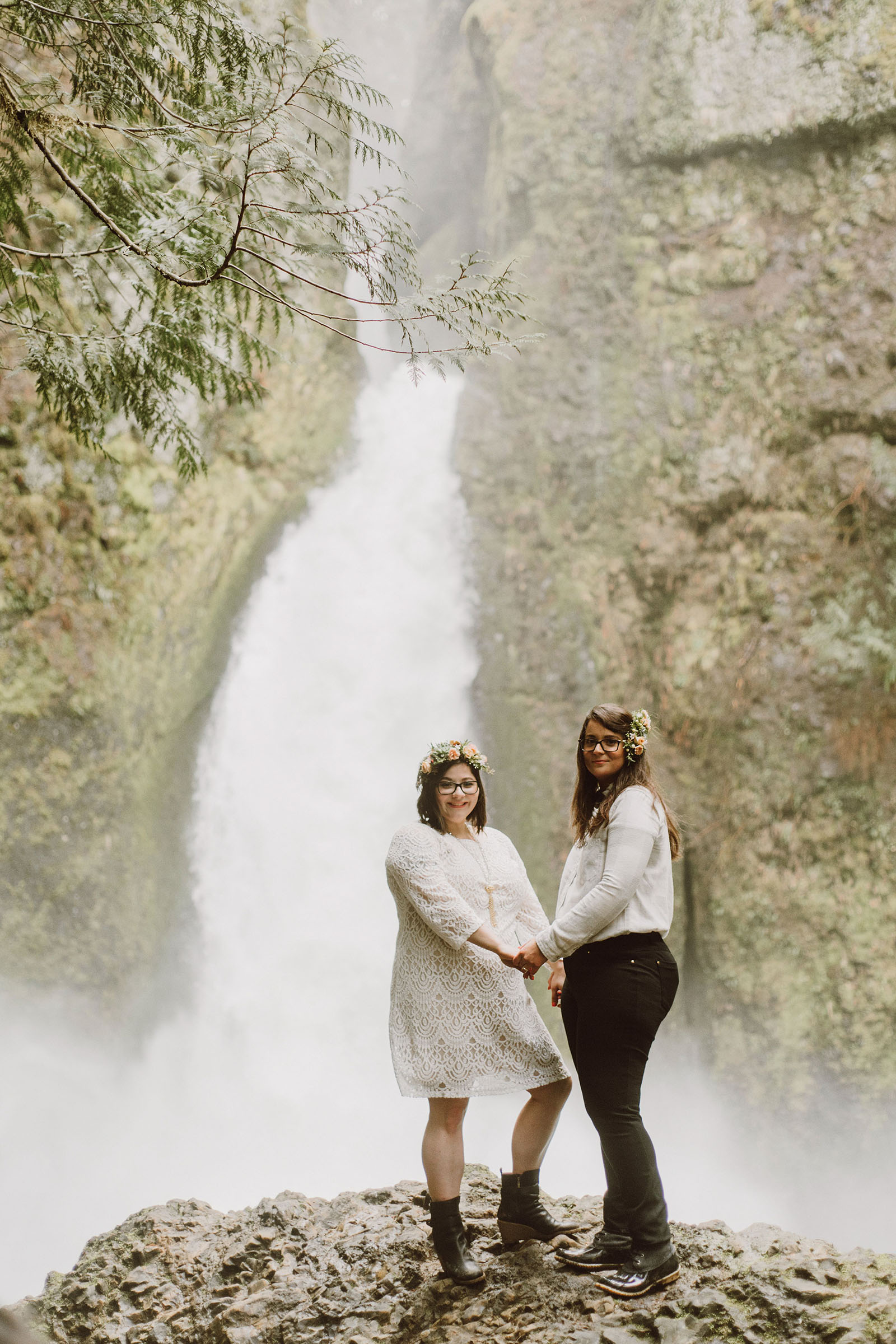 Newlywed couple posing in front of Wahclella Falls at a Portland waterfall elopement