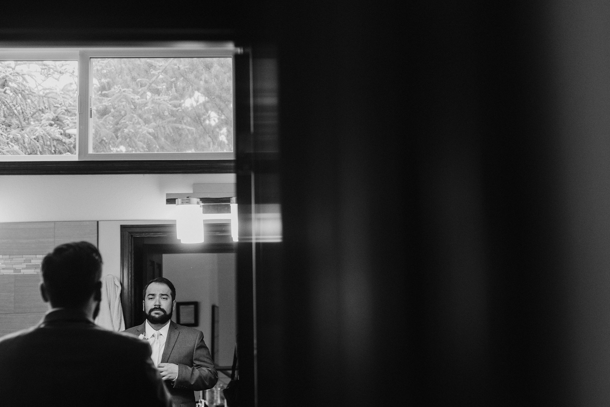 Groom getting dressed in the mirror | Portland Wedding Photographer