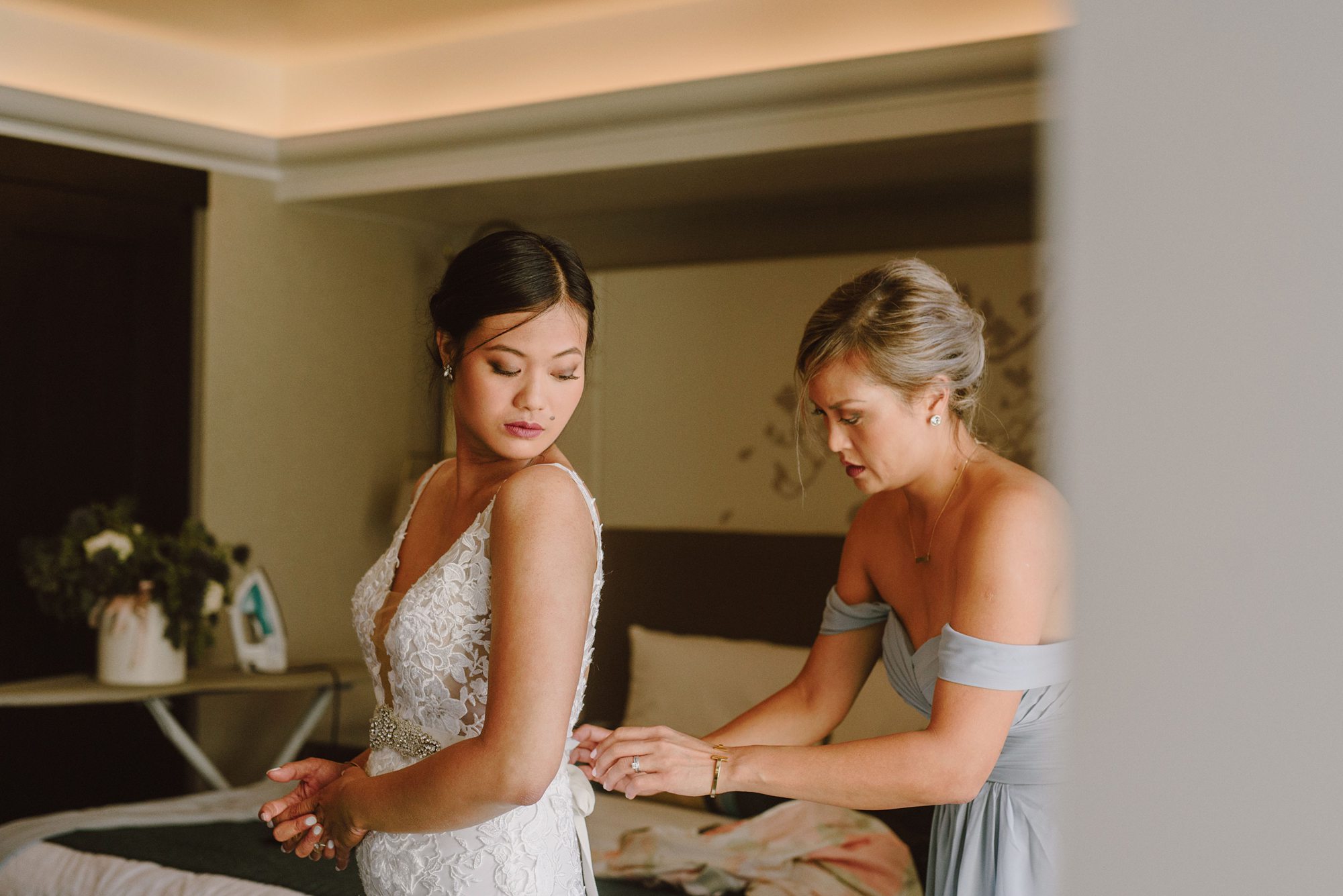 Bride getting zipped into dress by her sister | Portland Wedding Photographer