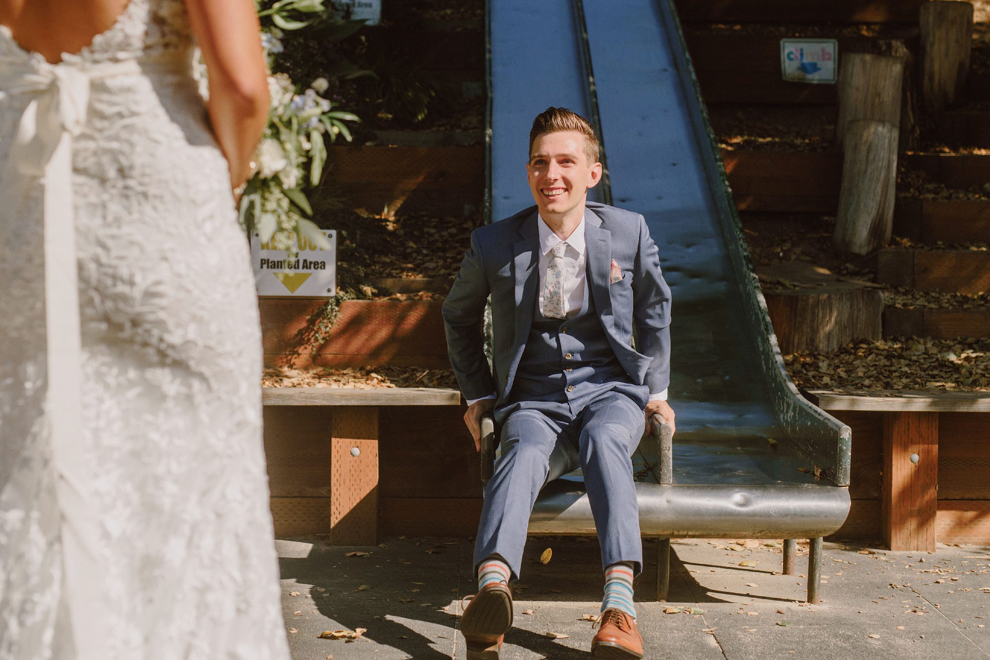 Groom riding down a slide to meet his Bride | San Francisco Wedding Photographer