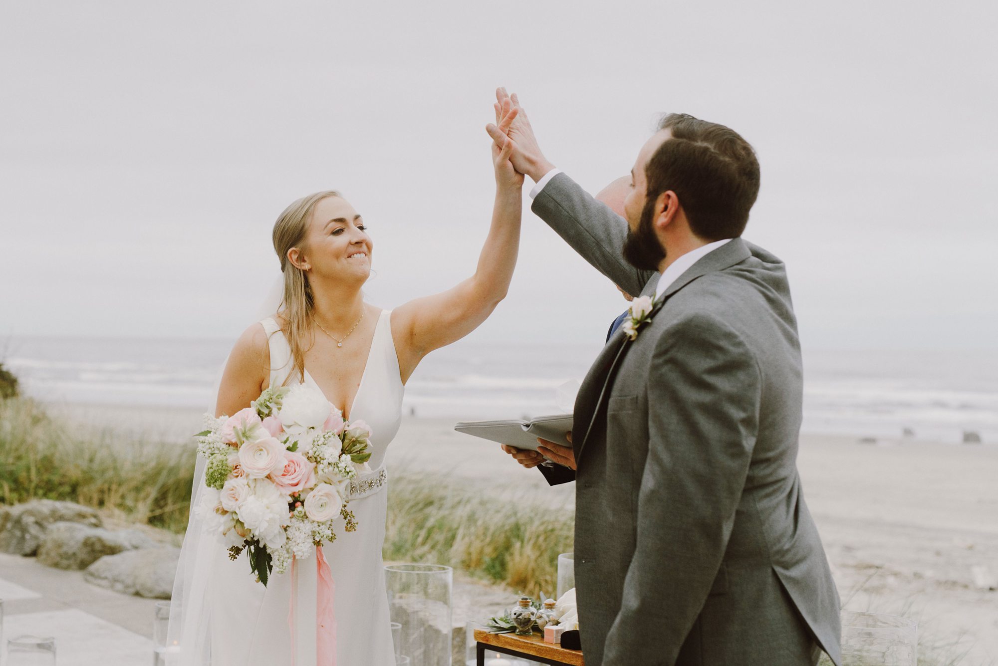 Bride and Groom high fiving at the end of their wedding ceremony