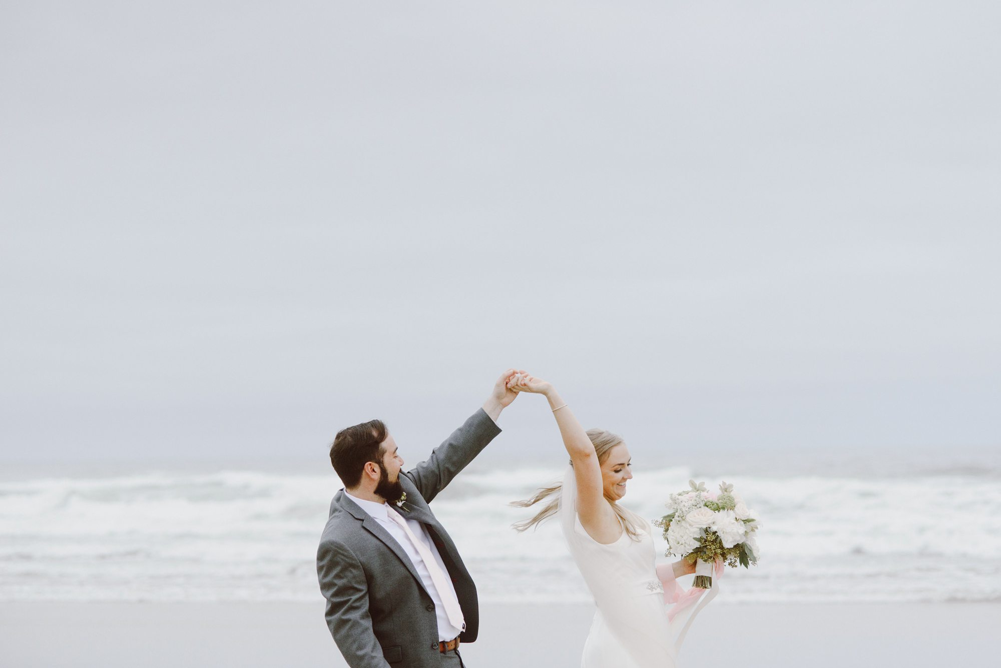 Bride and groom dancing on the Oregon Coast