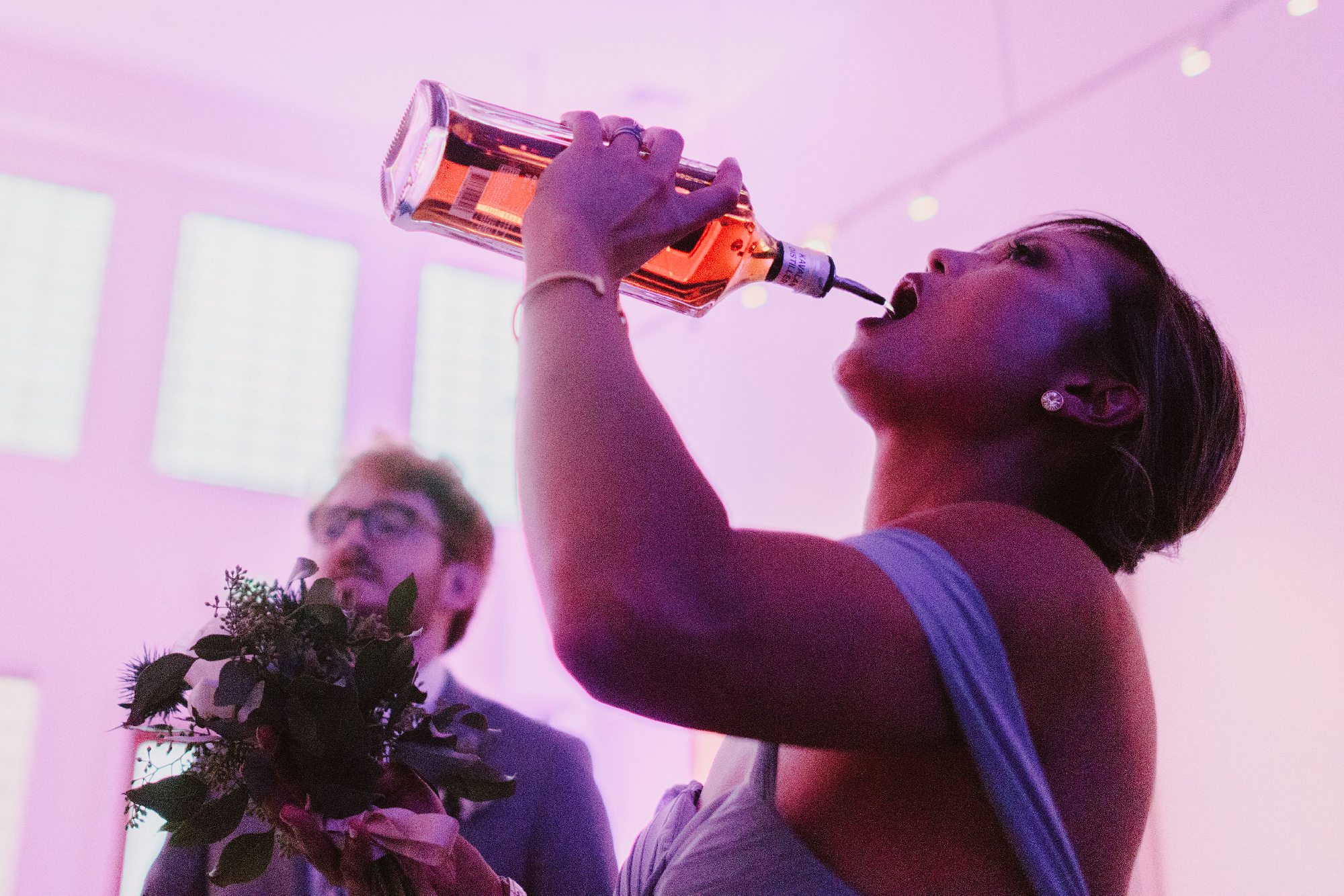 Maid of honor pouring liquor in her mouth at Foreign Cinema in San Francisco, CA