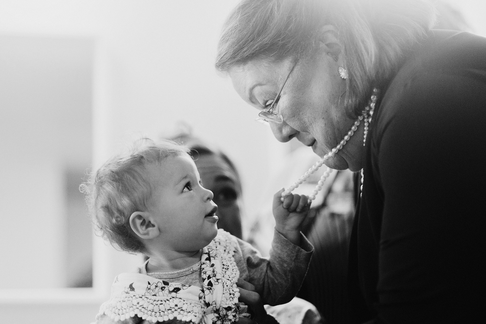 Baby tugging on her grandmother's pearl necklace - Columbia River Gorge wedding