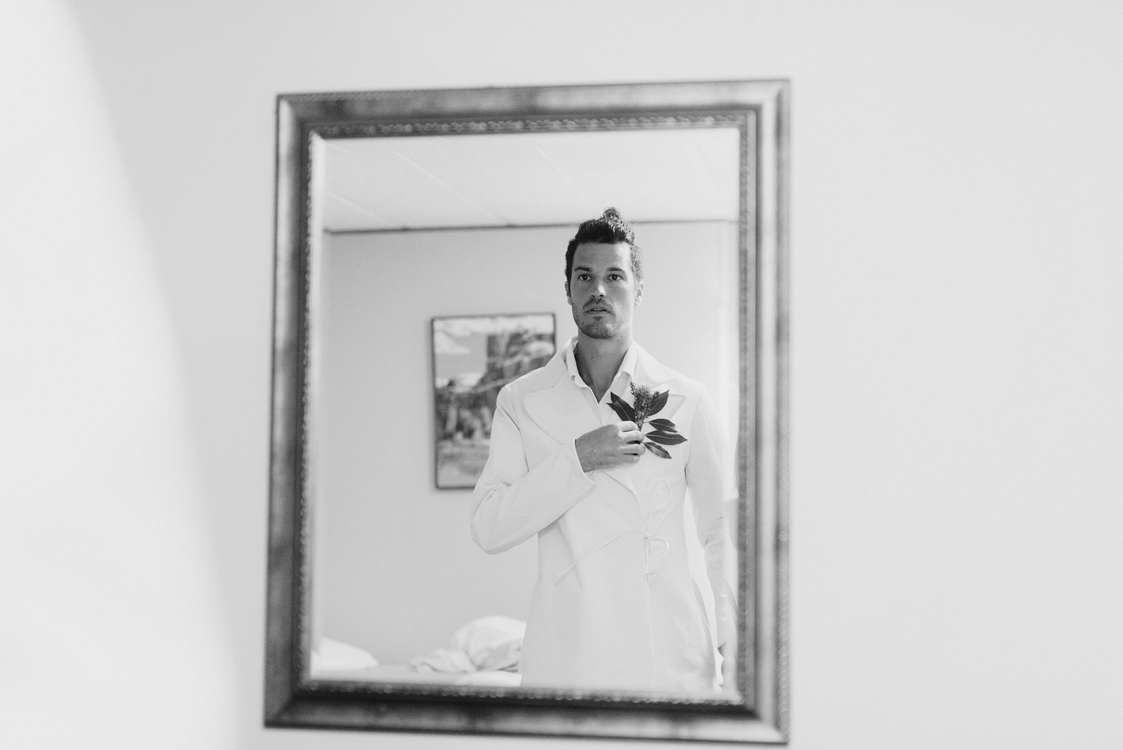 Groom getting dressed while looking in the mirror - Columbia Gorge River Wedding in Oregon