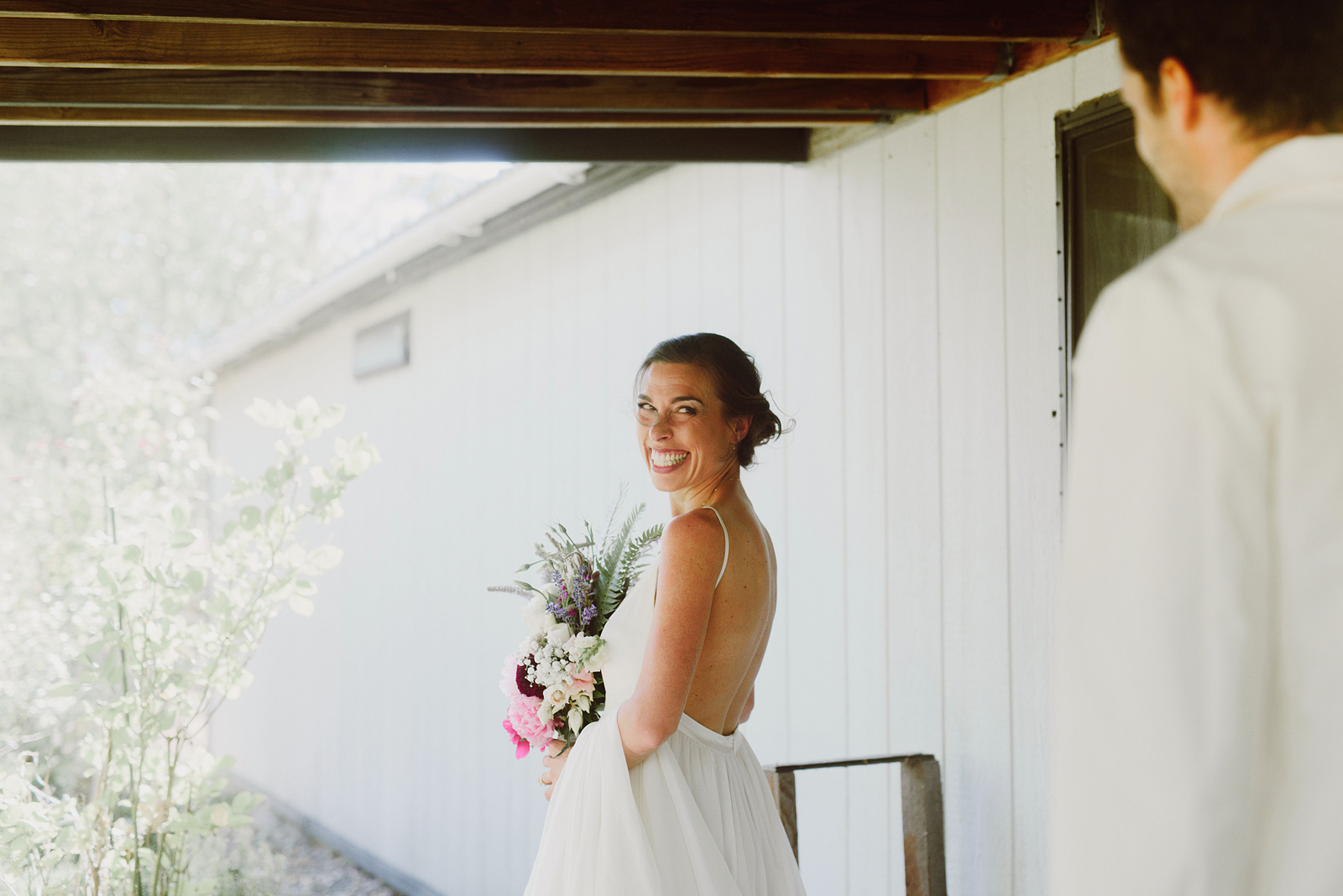 Bride looking over her shoulder to see the groom for the first time - Columbia River Gorge wedding