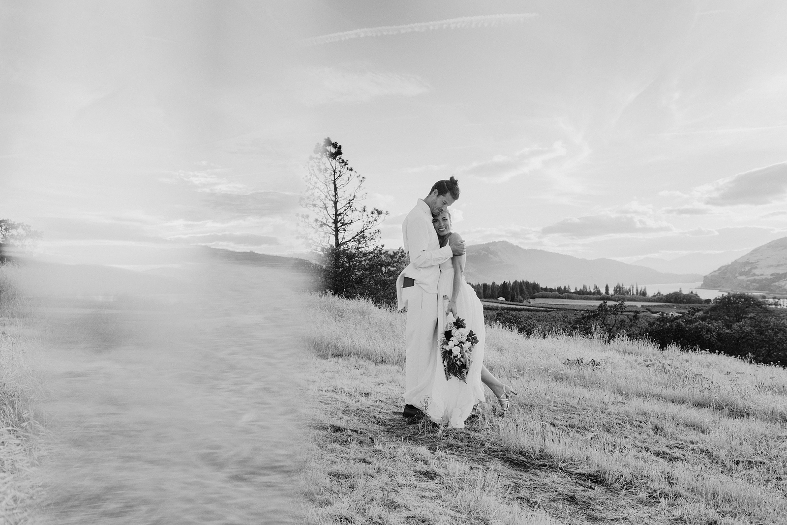 Black and white prism portrait of bride and groom standing in an open field - Columbia River Gorge wedding in Mosier, OR
