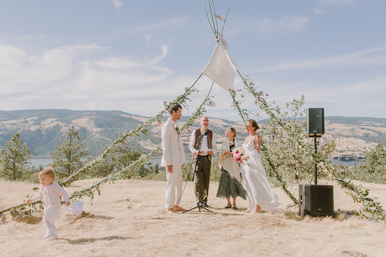 Toddler running away during an emotional Columbia Gorge River wedding ceremony in Oregon