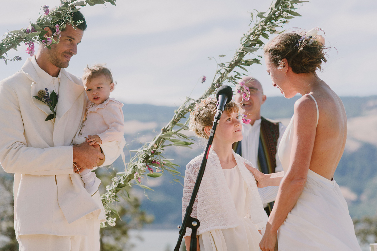 Bride and Groom exchanging vows with their daughters - Columbia River Gorge wedding in Mosier, OR