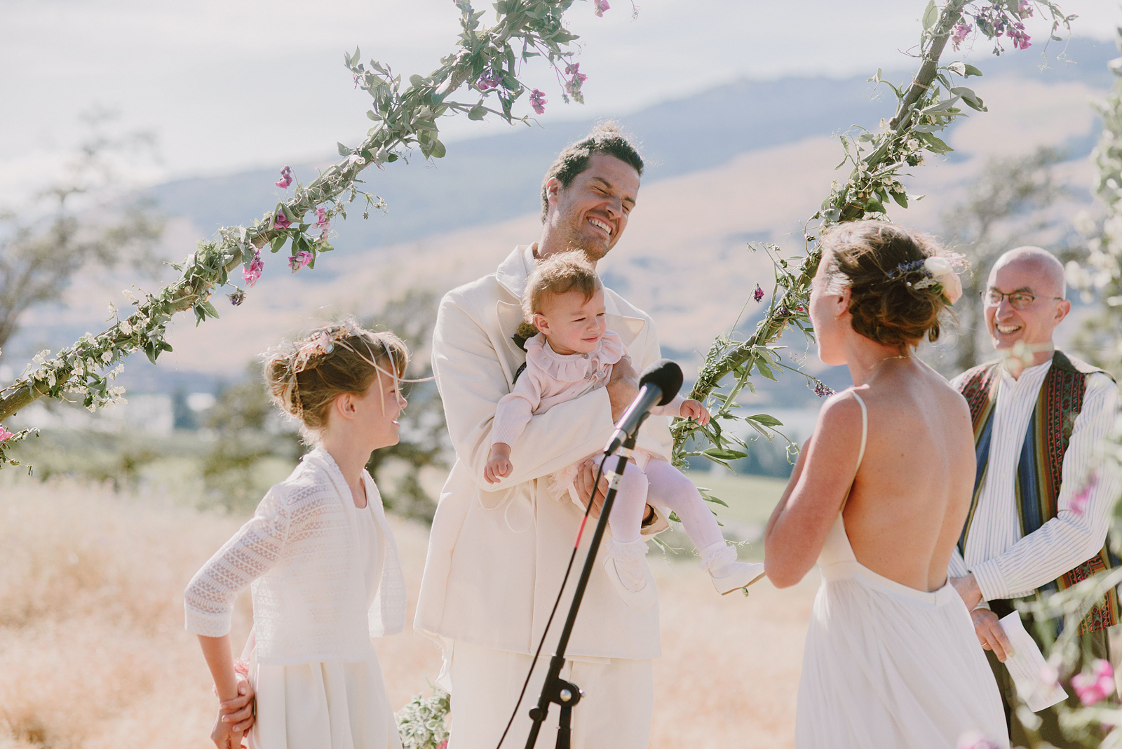 Bride and groom exchanging vows with their daughters during a Columbia Gorge River Wedding in Oregon