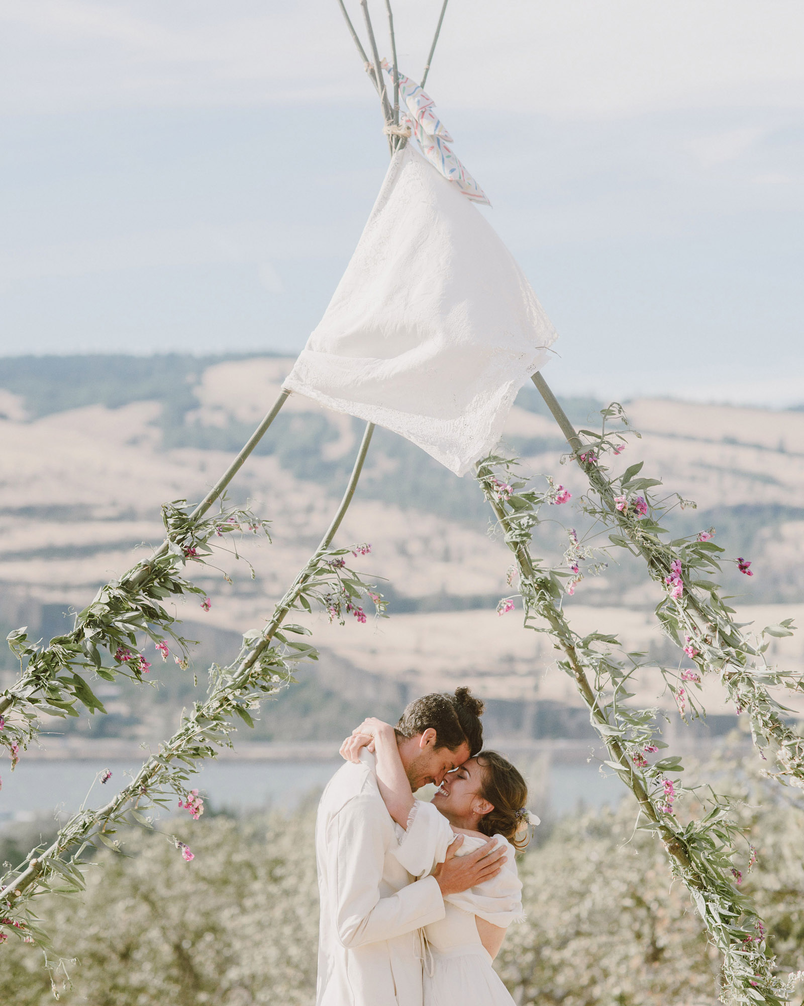Bride and Groom's first kiss at the end of their Columbia Gorge River wedding ceremony