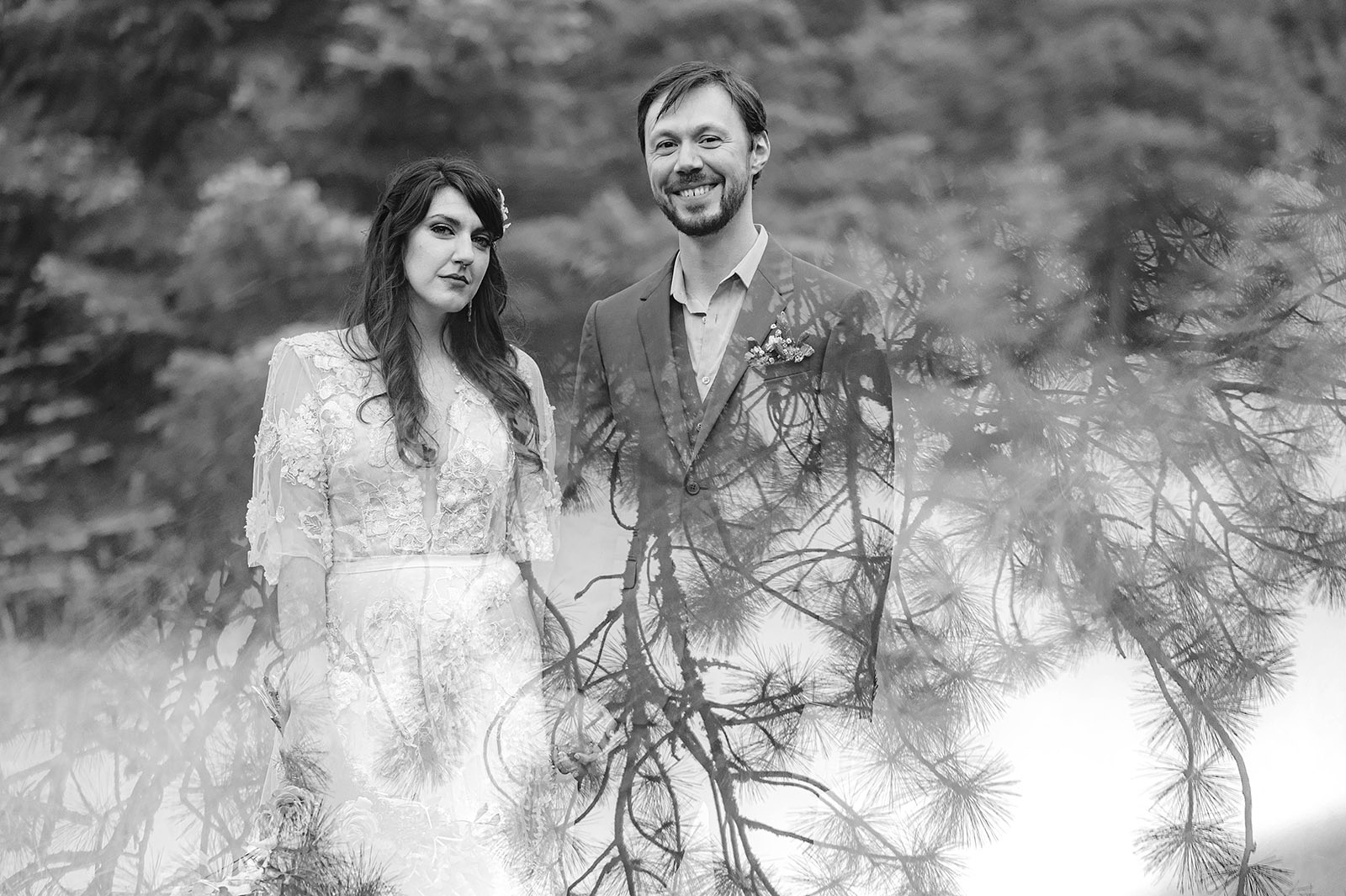 Black and white portrait of Bride and Groom fading into the pine trees - Trout Lake Wedding, WA