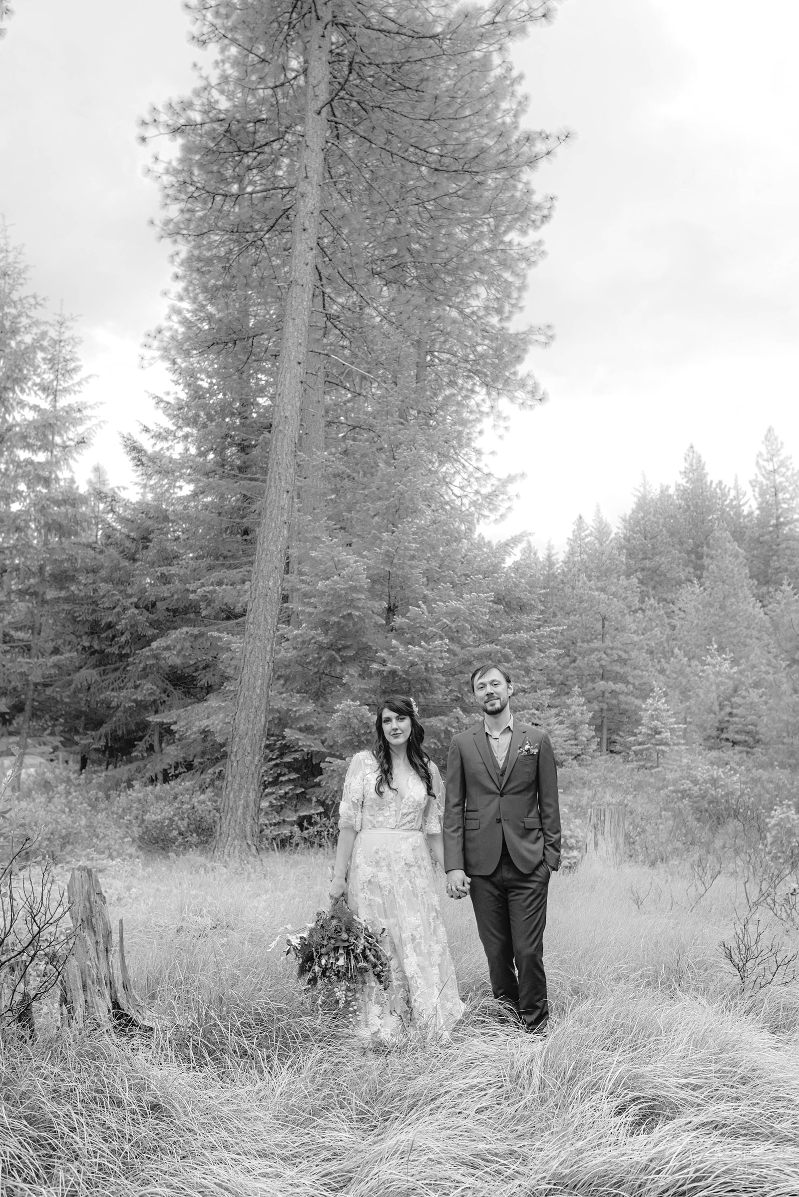 Vintage black and white portrait of Bride and Groom standing in a field of tall grass - Trout Lake Wedding, WA