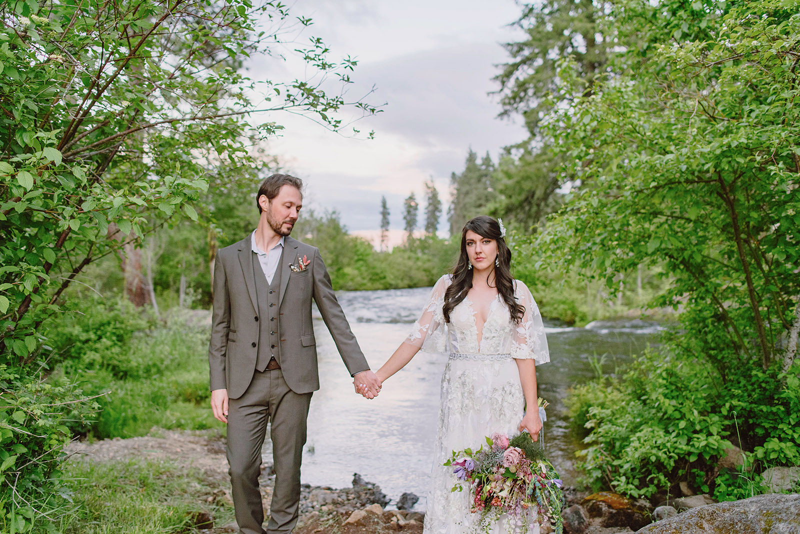 Bride and Groom holding hands in front of a creek near Hollenbeck Park - Trout Lake Wedding, WA
