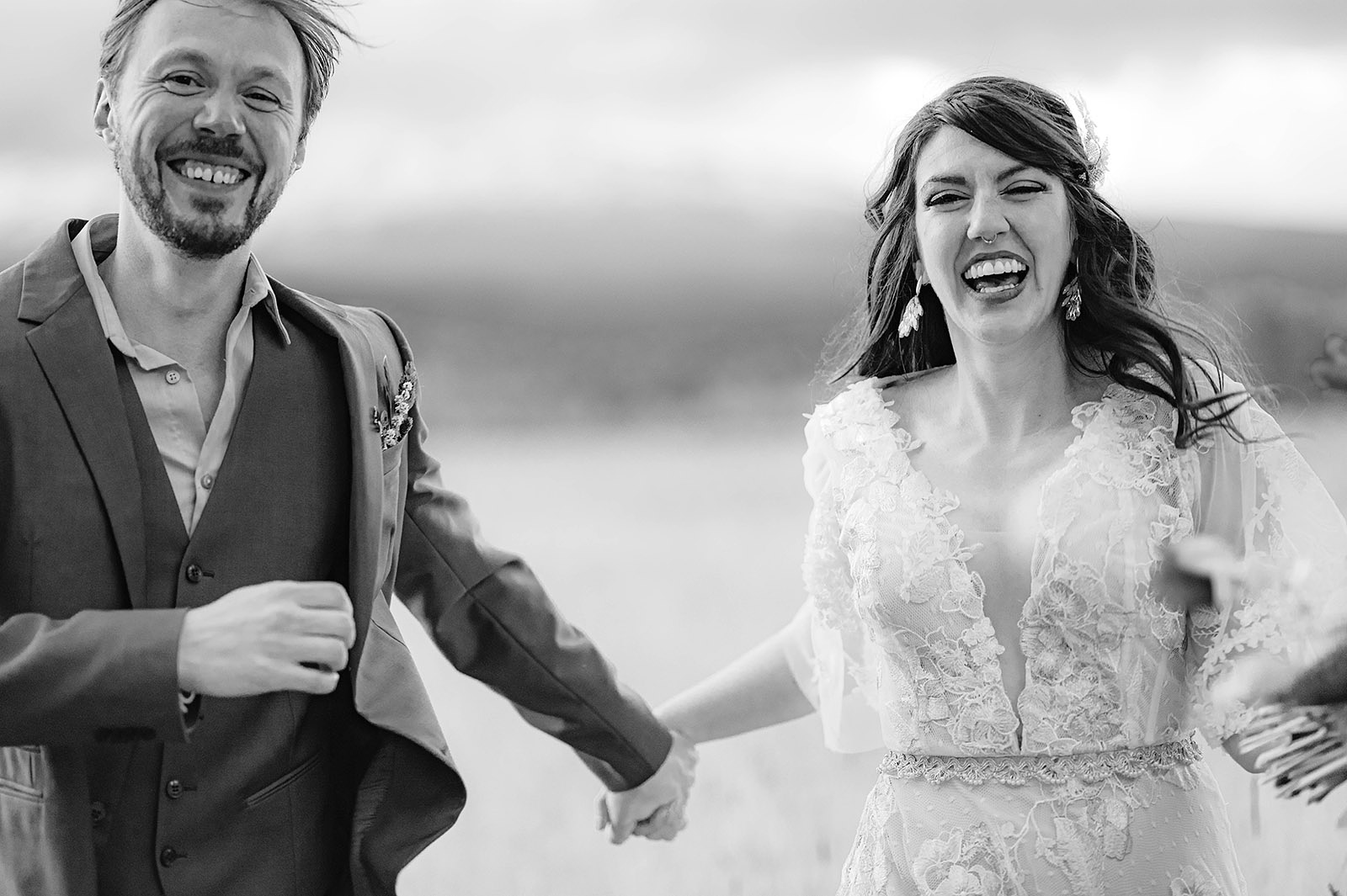 Bride and Groom laughing while running towards the camera - Trout Lake Wedding, WA