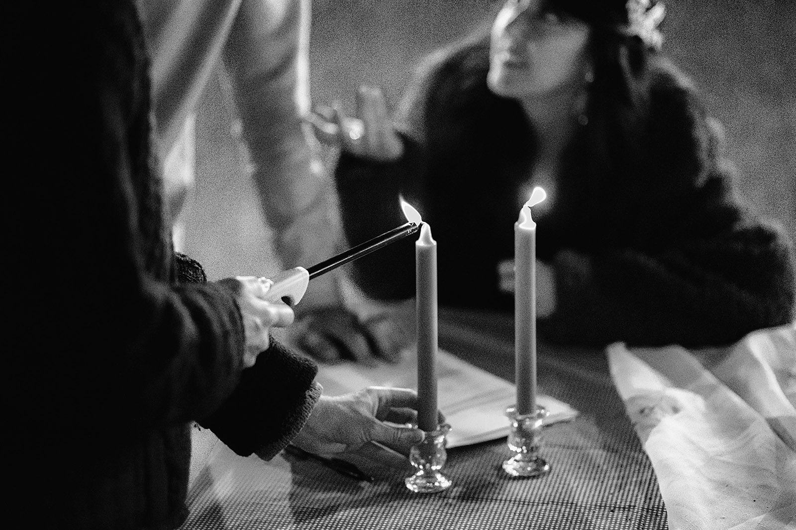 Officiant lighting candles while preparing to sign official documents - Trout Lake Wedding, WA