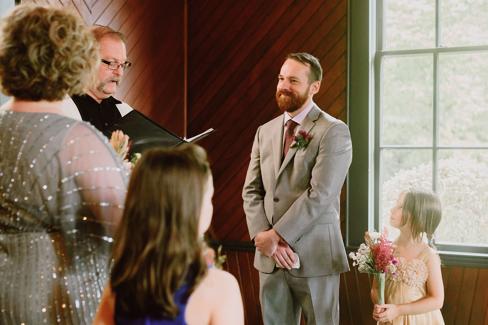 Groom smiling at his bride during the ceremony - Oaks Pioneer Church Wedding