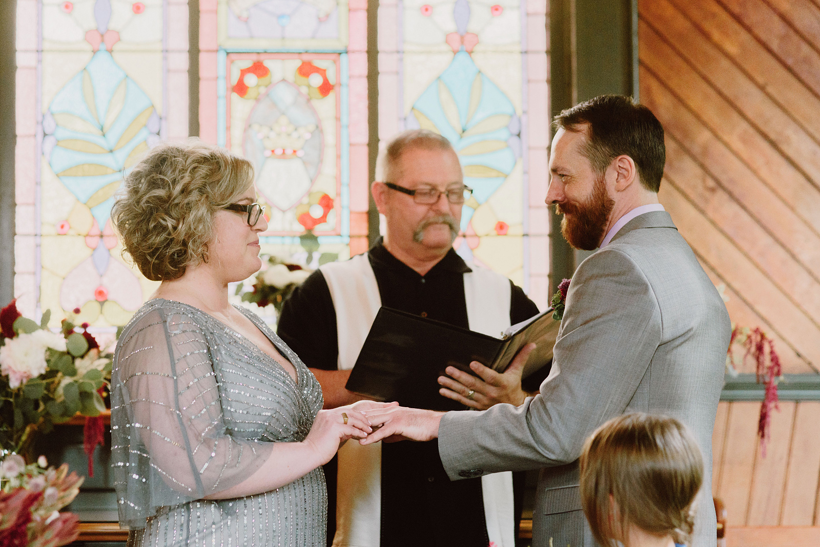 Couple exchanging rings during a church ceremony - Oaks Pioneer Church Wedding in Sellwood, OR