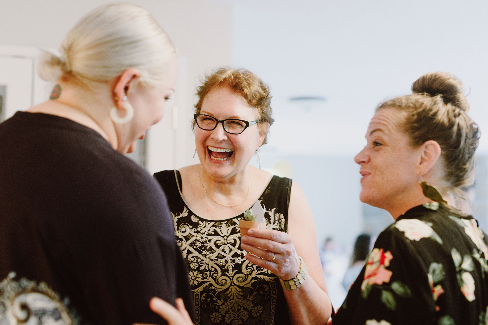 Candid photo of guests laughing at the afterparty - Oaks Pioneer Church Wedding