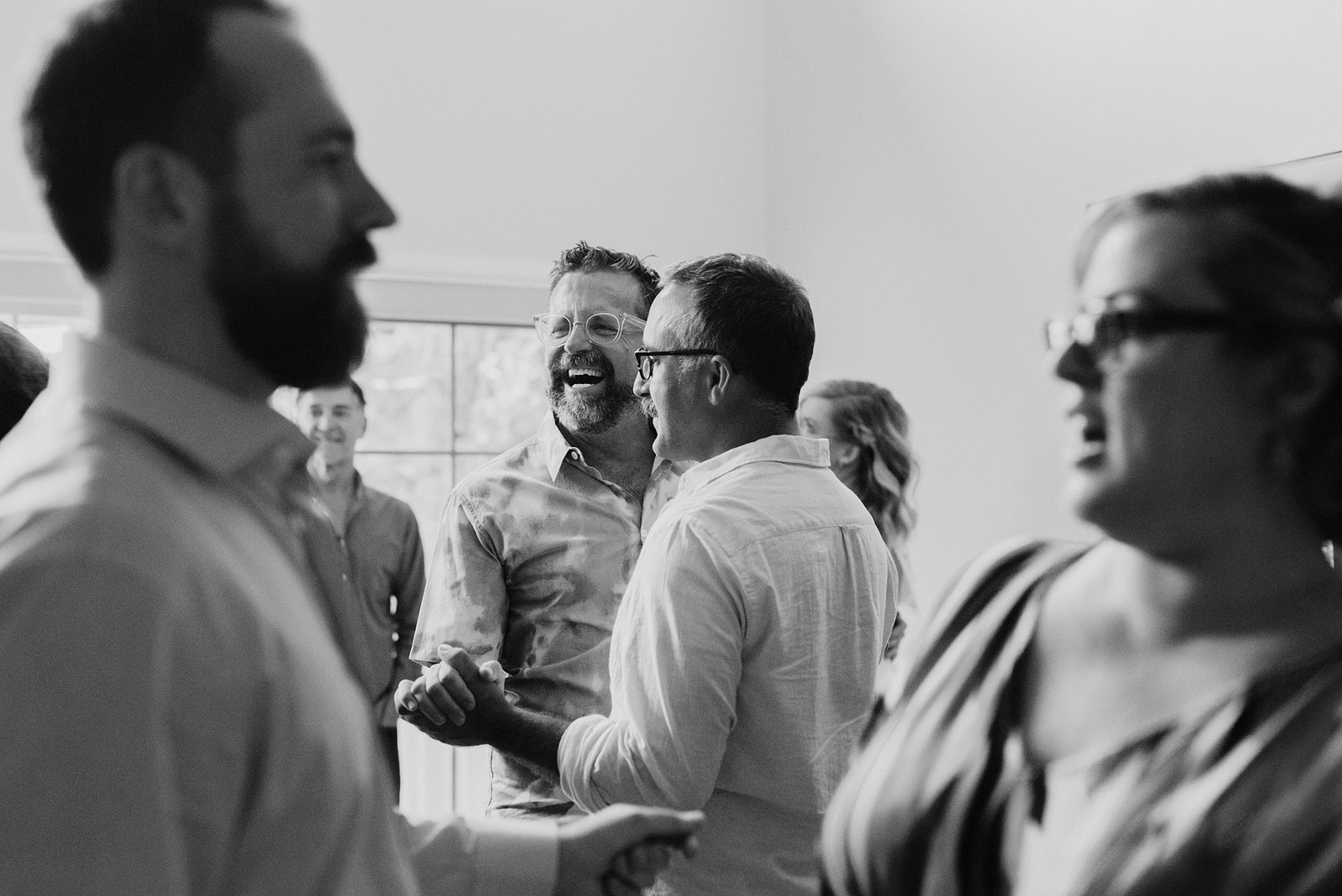 Black and white photo of couples dancing at the afterparty of an Oaks Pioneer Church Wedding in Sellwood, OR