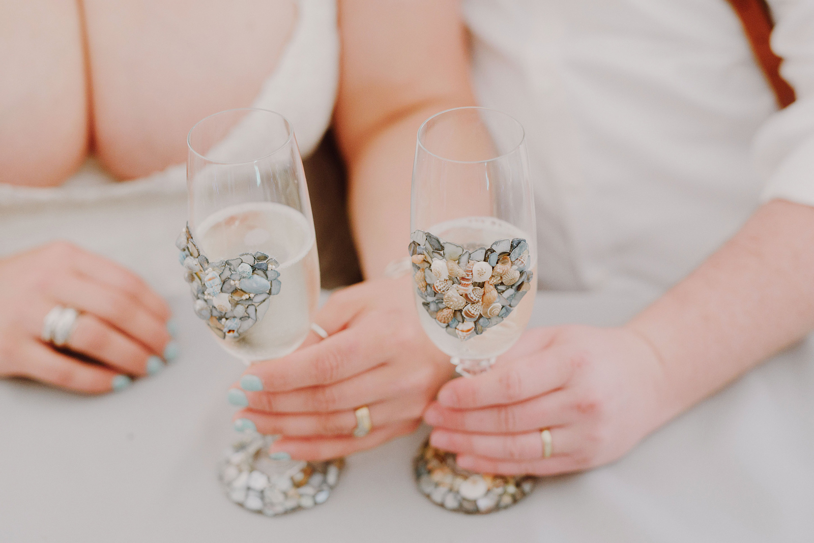 Champagne glasses decorated with shells found on the beach - Oceanside Community Club Wedding on the Oregon Coast” title=